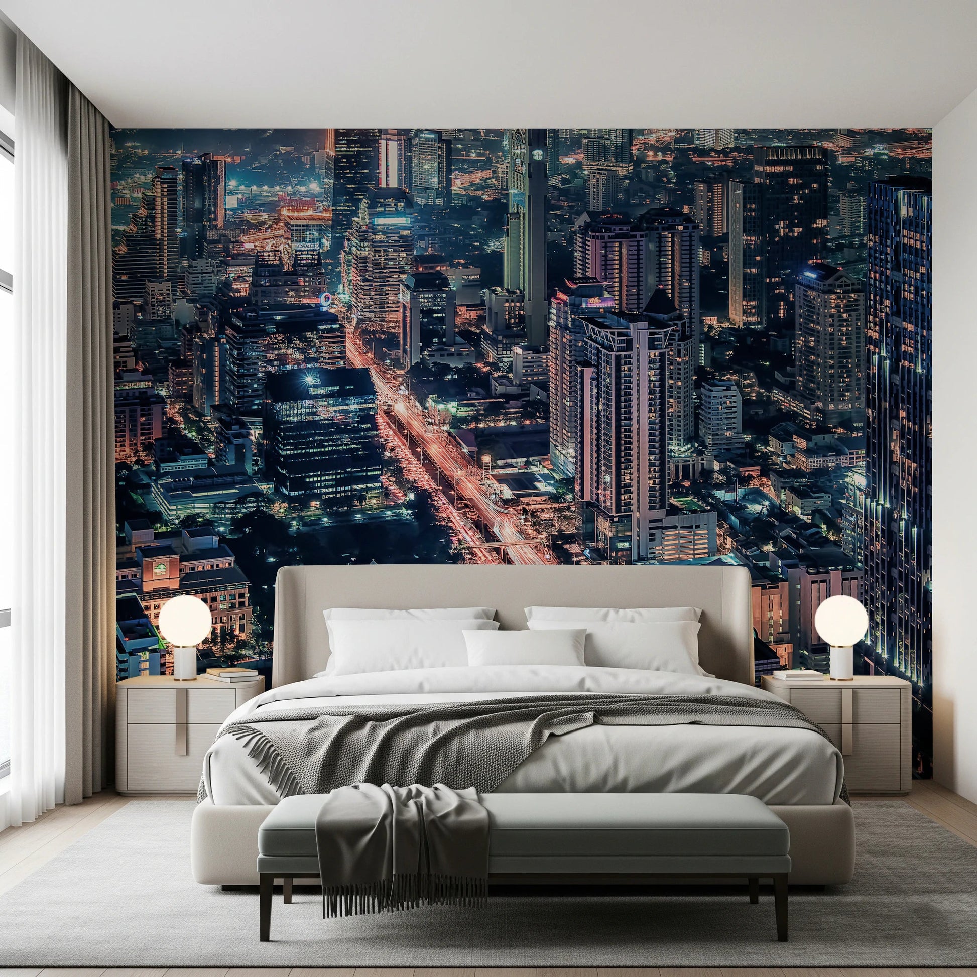 Cityscape Night wallpaper mural of skyscrapers at dusk behind a cream upholstered bed with globe lamps