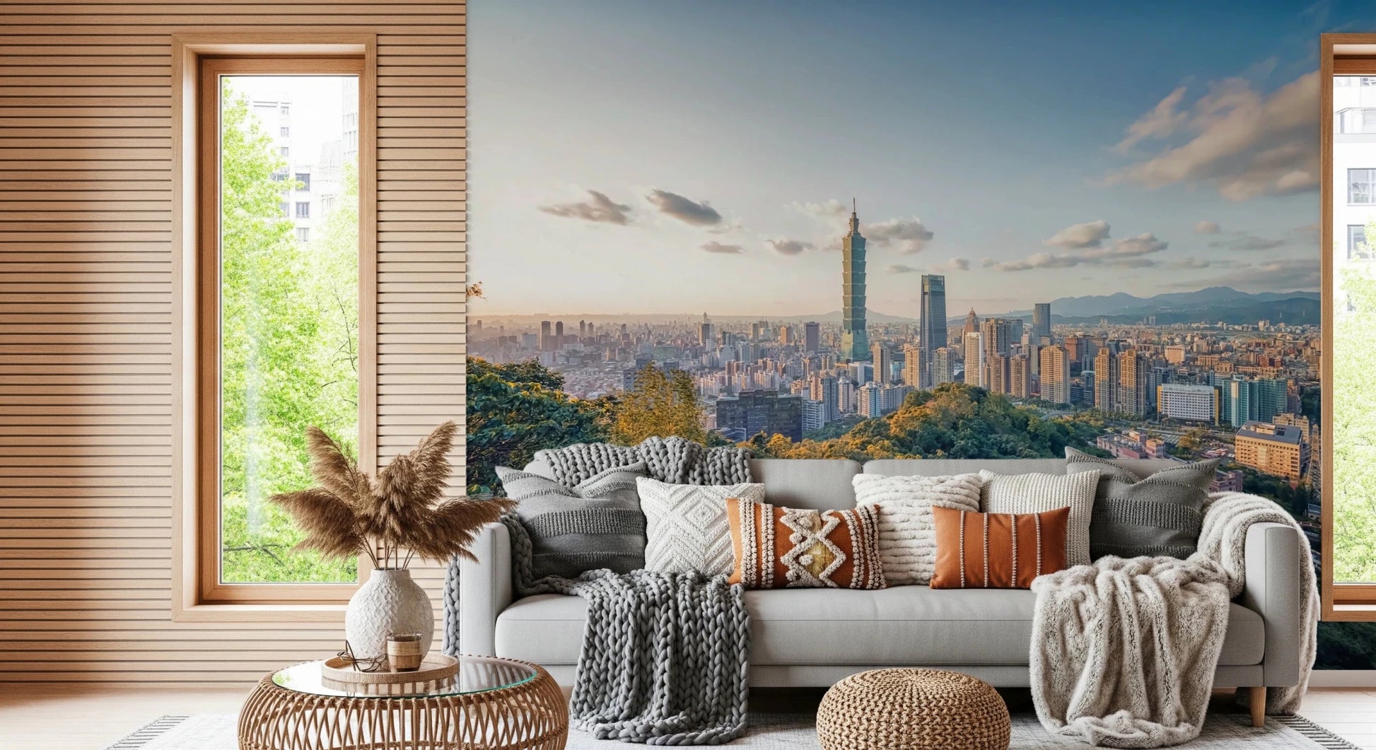 Cityscape Vista wallpaper mural of Taipei over forested hills behind a green sofa and cream lounge chair