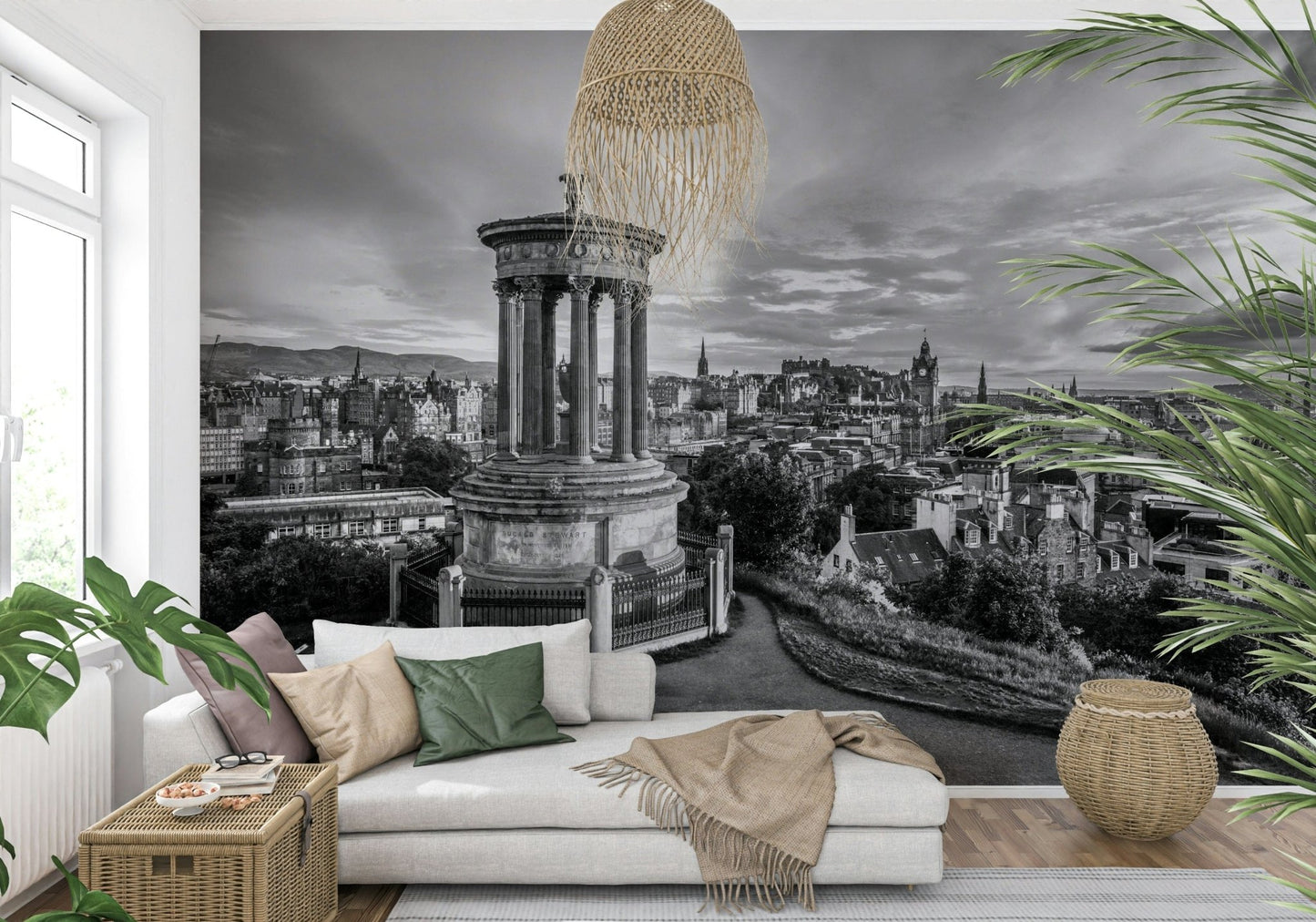 Classical City Charm wallpaper mural of monochrome Edinburgh behind a cream sofa with green cushions and rattan baskets