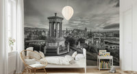 Classical City Charm wallpaper mural showing monochrome Edinburgh cityscape behind a white child's bed, rattan chair and bookshelf