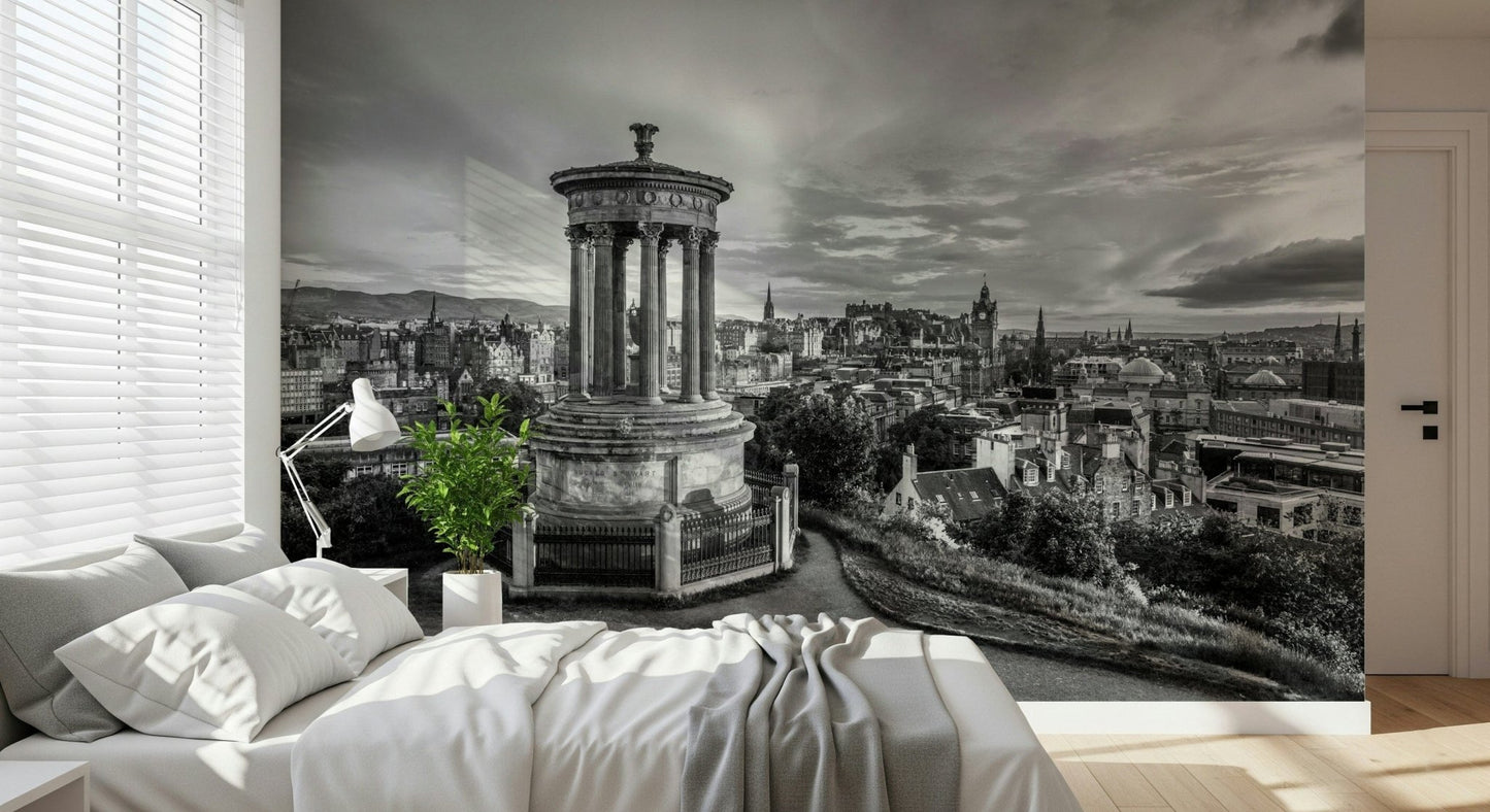 Classical City Charm wallpaper mural of Edinburgh monument behind a bedroom bed with white bedding, task lamp and potted plant