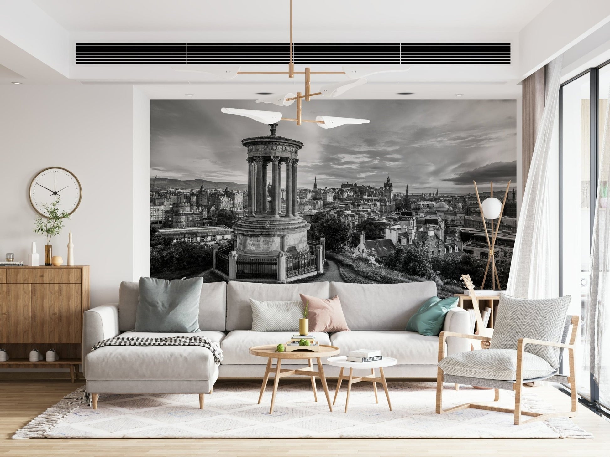 Classical City Charm wallpaper mural of Edinburgh skyline behind a cream sectional sofa with pastel cushions and wood sideboard