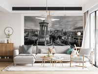 Classical City Charm wallpaper mural of Edinburgh skyline behind a cream sectional sofa with pastel cushions and wood sideboard