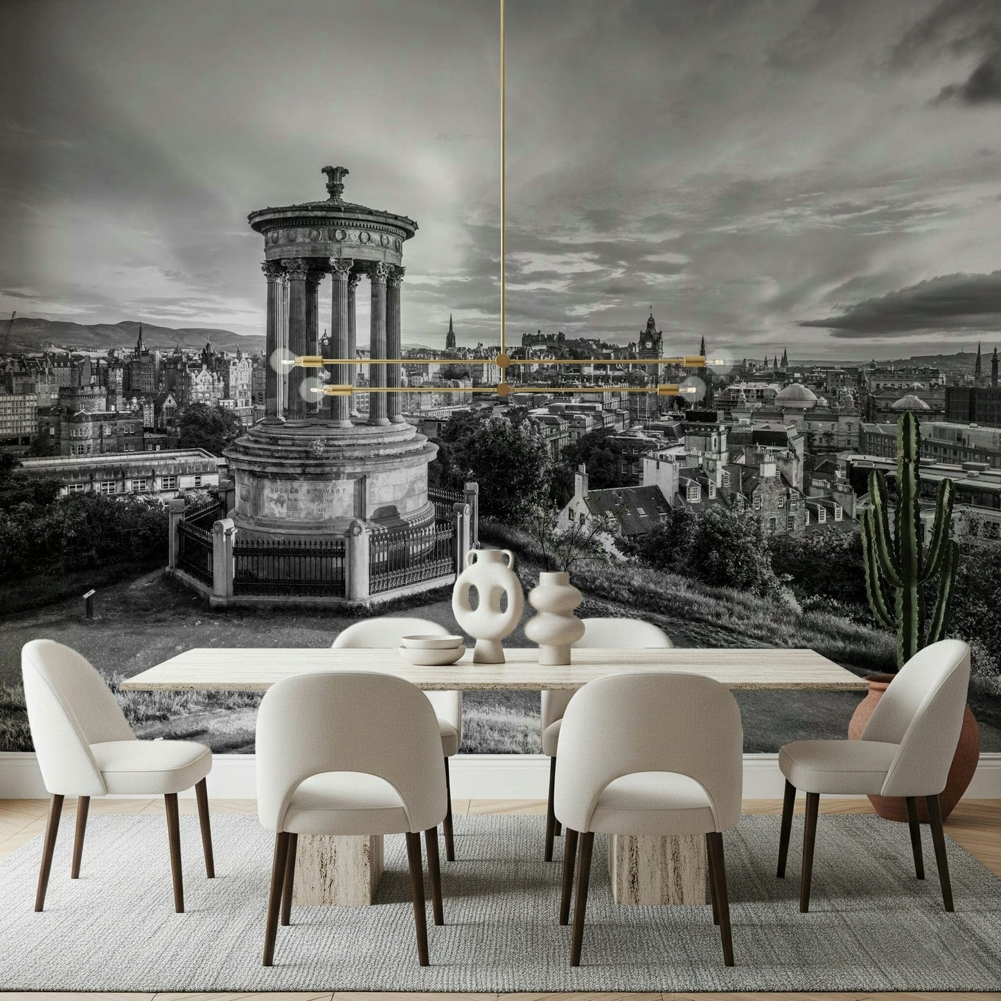 Classical City Charm wallpaper mural of monochrome Edinburgh behind a light wood dining table with cream chairs and brass pendant