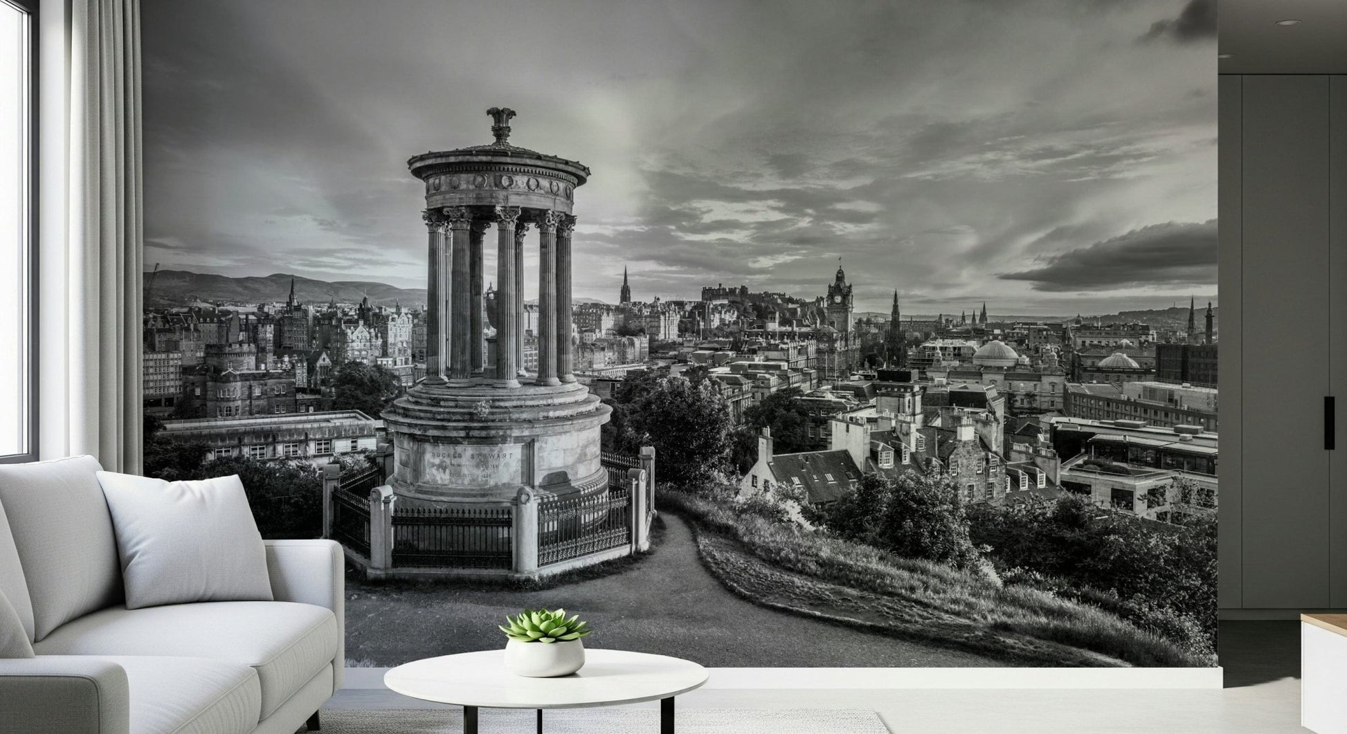 Classical City Charm wallpaper mural of Edinburgh skyline behind a white sofa and round side table with a small succulent