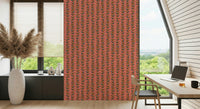 Stylized retro leaves in cheerful tones forming repeating vine stripes on a warm pink wallpaper.