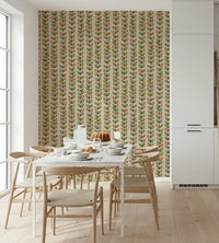 An off-white wallpaper decorated with repeating vintage-style vines and outlined multicolored leaves.