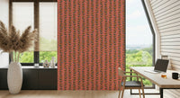 Stylized retro leaves in cheerful tones forming repeating vine stripes on a warm pink wallpaper.