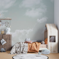 Installation process photograph: applying the seamless decorative cloud wallpaper.
