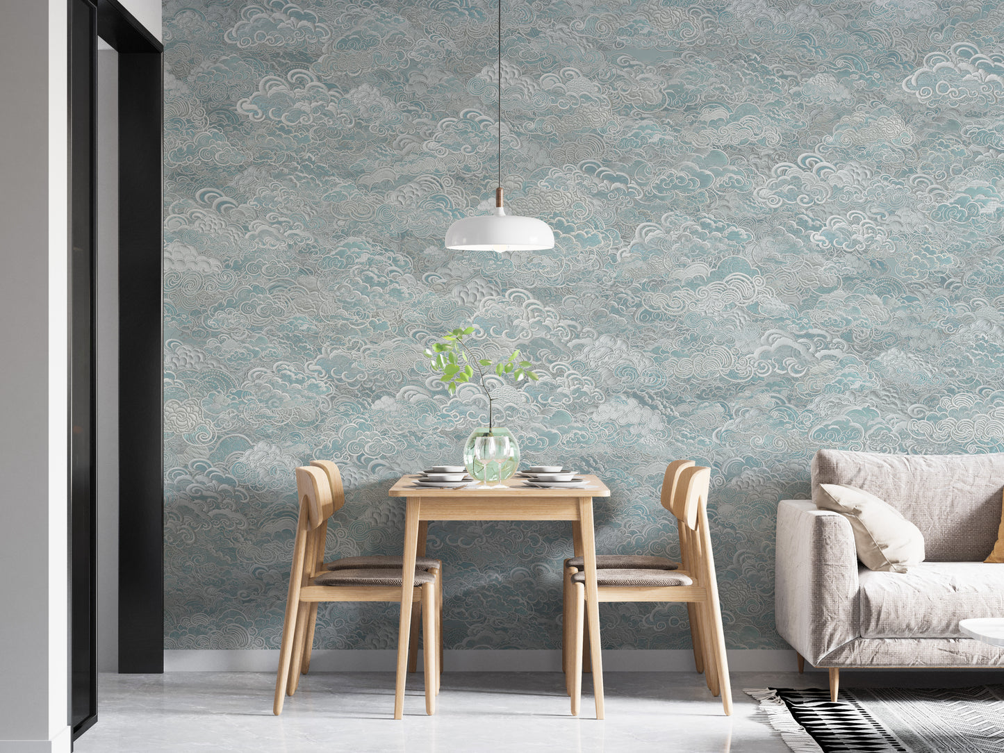 Clouds Baby Blue and White swirling cloud wallpaper mural beside a light wood dining table and grey sofa