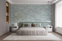 Clouds Baby Blue and White wallpaper mural behind a sage green bed with grey bedding and white nightstands