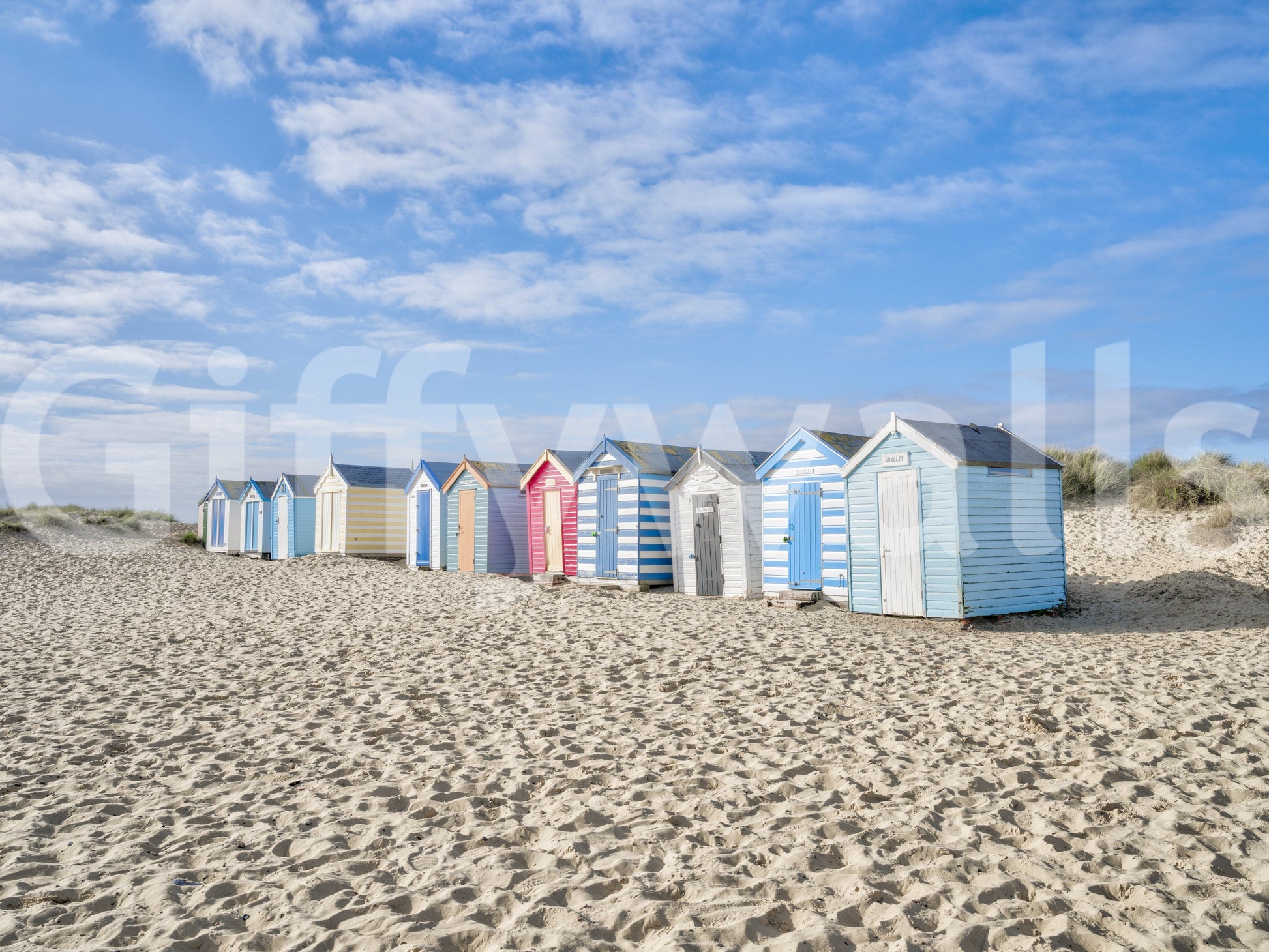 A detail of the warm tones in the beach huts and sky.

