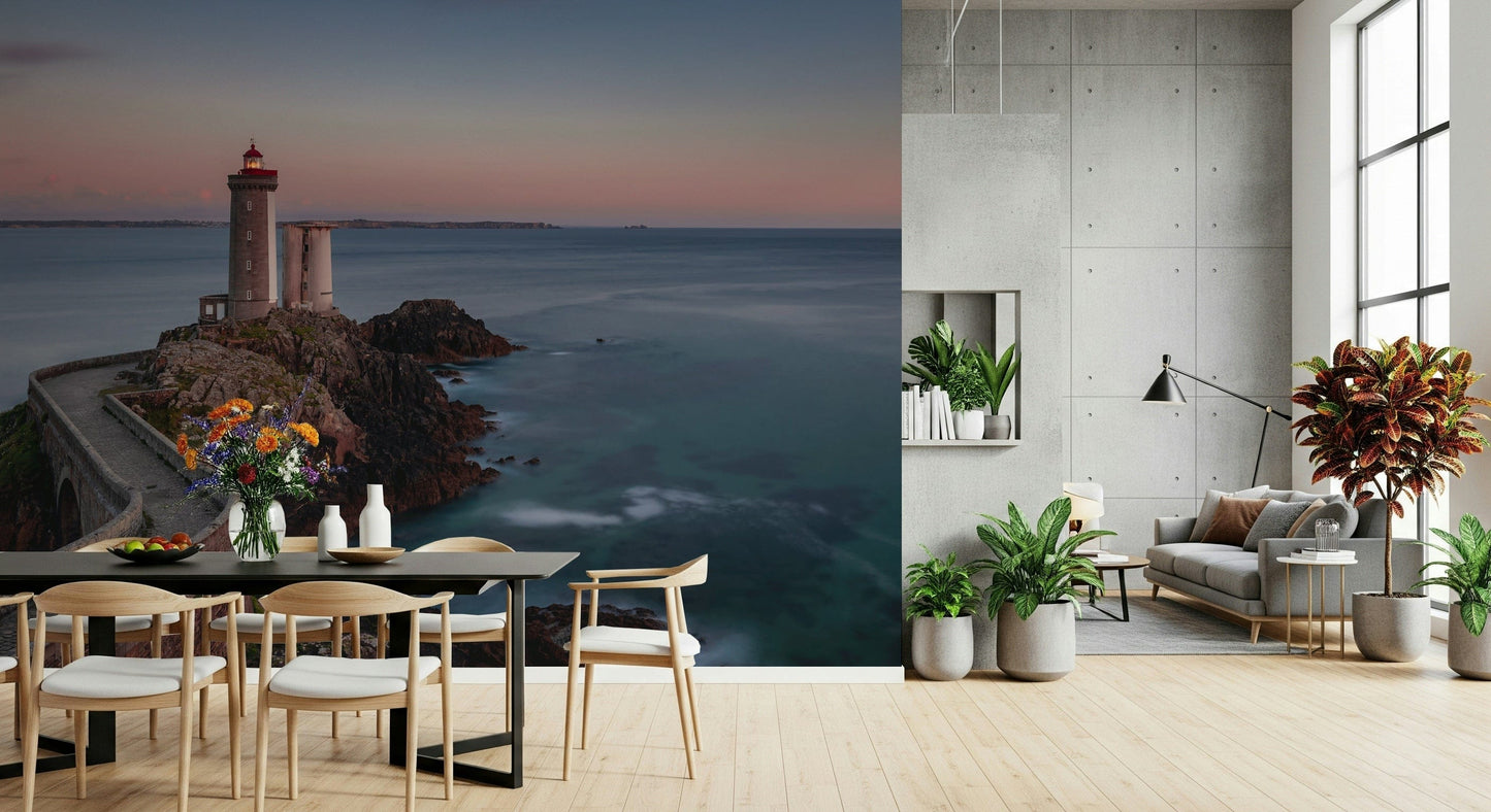 Peaceful seaside wallpaper with a guiding lighthouse and tranquil ocean reflections.