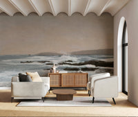 Coastal Hues wallpaper mural of a soft coastal scene behind a white sofa and cane sideboard in a living room