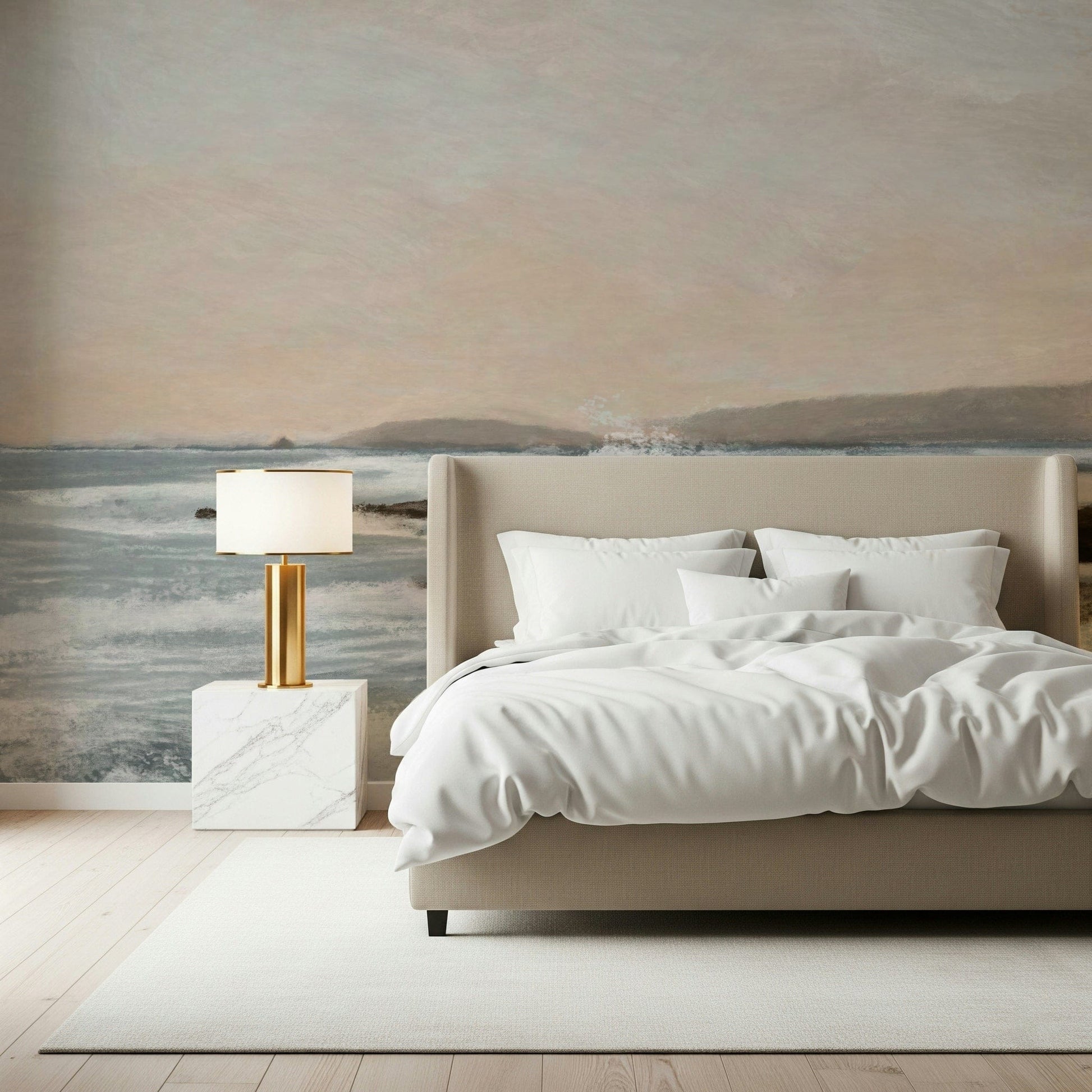 Coastal Hues wallpaper mural of a pale blue seascape behind a beige upholstered bed with white bedding in a bedroom