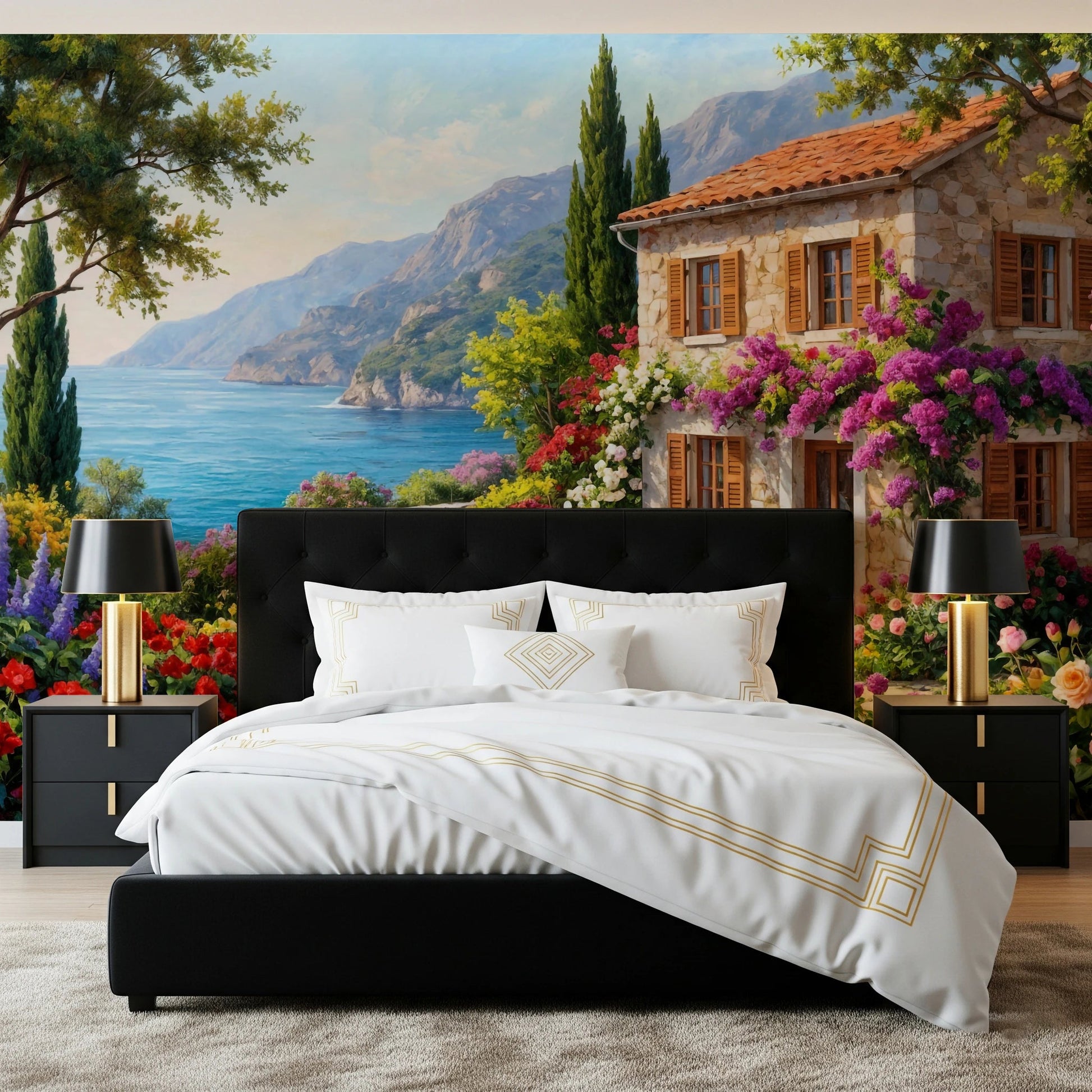 Coastal Cottage Bloom wallpaper mural with a seaside villa behind a black bed and gold lamps in a bedroom