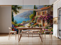 Coastal Cottage Bloom wallpaper mural of a Mediterranean stone house by the sea in a dining room with wood table