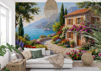 Coastal Cottage Bloom wallpaper mural with a flower-draped cottage and sea behind a white sofa in a living room