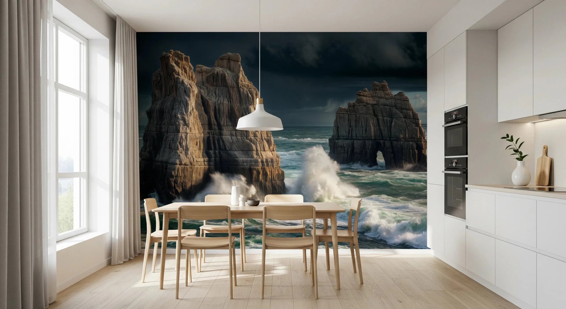 Coastal Giants wallpaper mural behind a wood dining table and chairs by a white kitchen with a pendant lamp