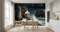 Coastal Giants wallpaper mural behind a wood dining table and chairs by a white kitchen with a pendant lamp