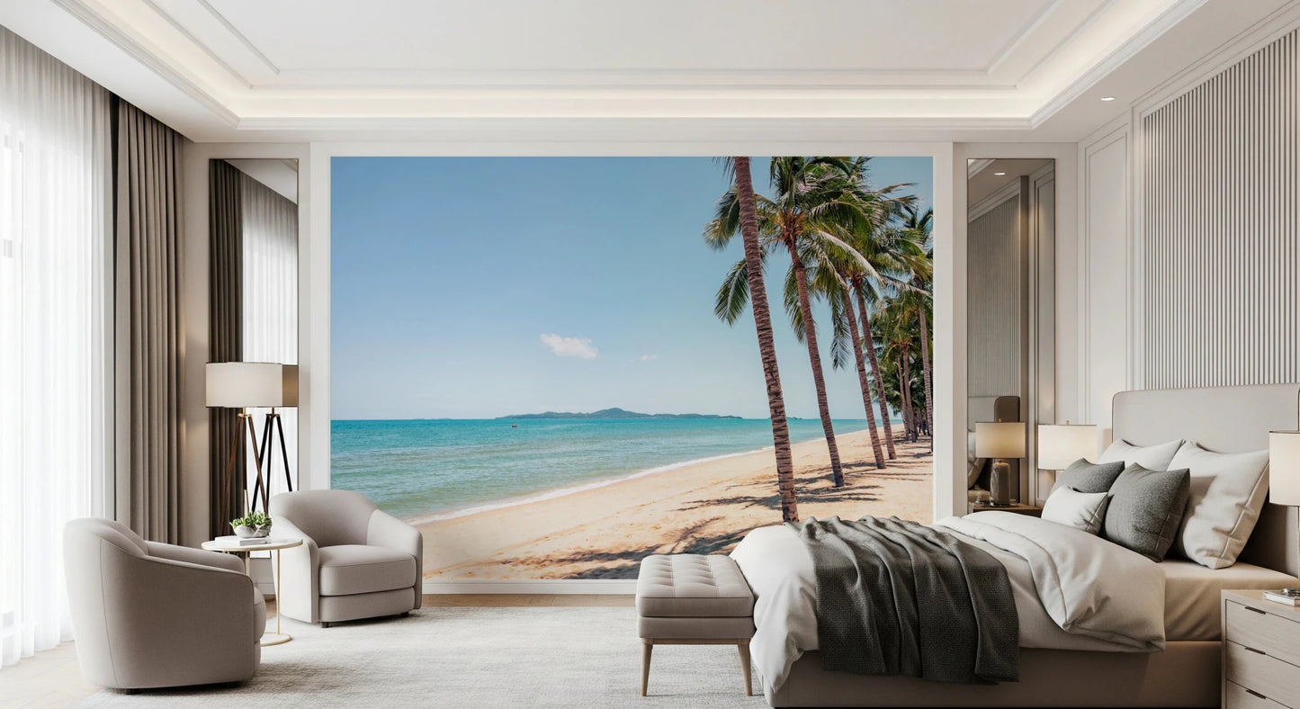 Coastal Palm Serenity wallpaper mural of calm turquoise sea and a sandy shore above a gray bed in a luxe bedroom