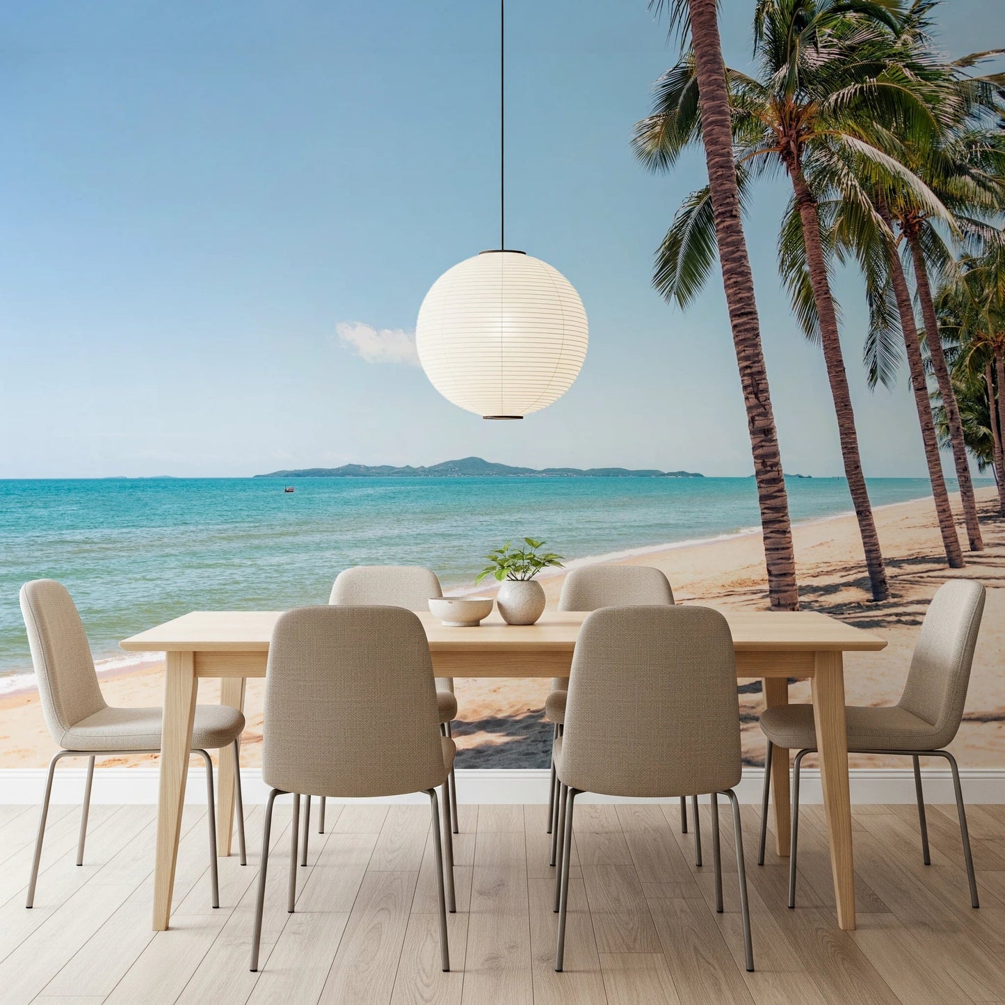 Coastal Palm Serenity wallpaper mural of beach and palms in a dining room with a wood table and round paper lantern