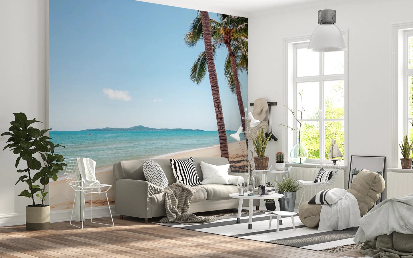 Coastal Palm Serenity wallpaper mural with palm-lined beach behind a gray sofa in a bright Scandinavian living room