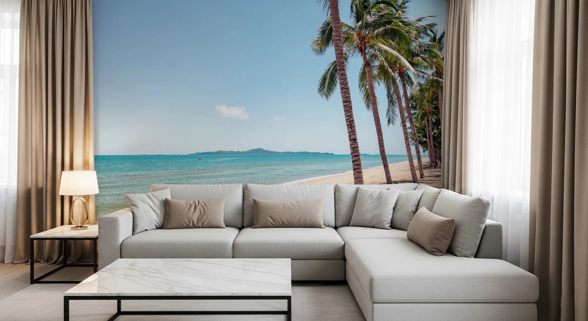 Coastal Palm Serenity wallpaper mural with turquoise sea and palms behind a gray L-sectional in a bright living room