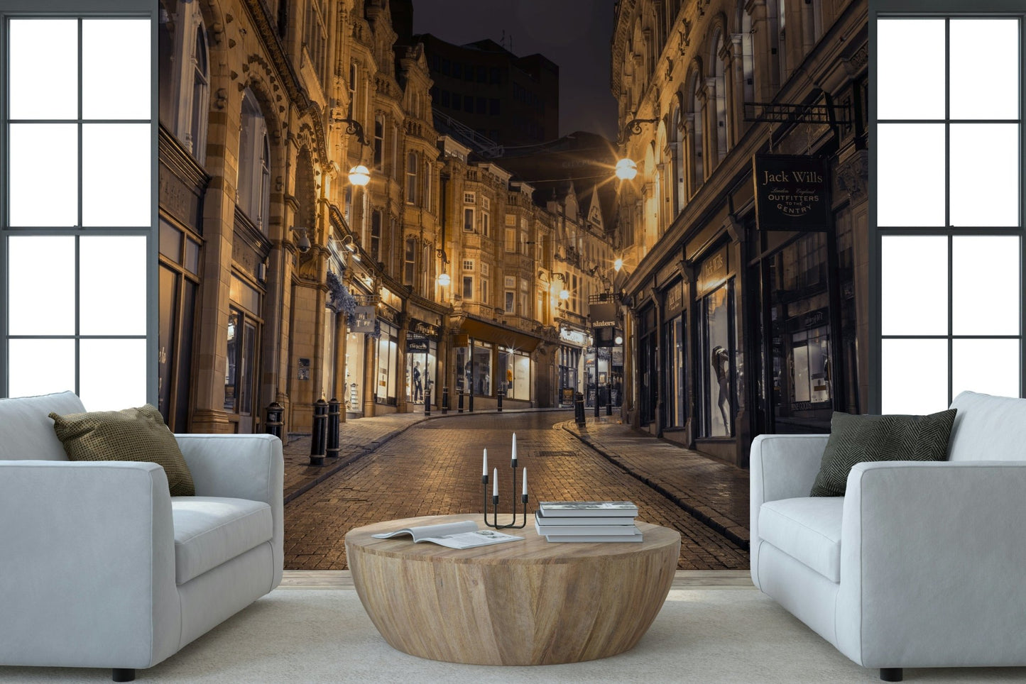 Cobblestone Street Nights wallpaper mural behind two white armchairs and a round wood table in a living room