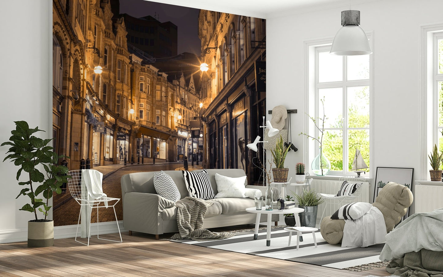 Cobblestone Street Nights wallpaper mural behind a grey sofa and wire chair in a Scandi living room