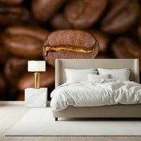 The wallpaper uses depth-of-field effects to make a single coffee bean stand out against a soft, blurred background.