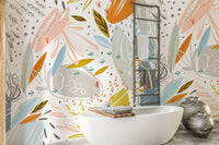 Colorful Floral Doodle wallpaper beside a freestanding white bathtub and towel ladder in a bathroom