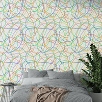 Minimalist apartment bedroom styled with colorful linear wall art.