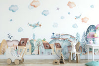 Watercolor Fun Village kids room wallpaper mural as a feature wall in a home office workspace