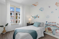 Watercolor Fun Village kids room wallpaper mural styled as a feature wall behind a dining table and chairs