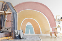 Watercolor Rainbow Colorful wallpaper mural in pink and yellow behind a canopy house bed with fairy lights