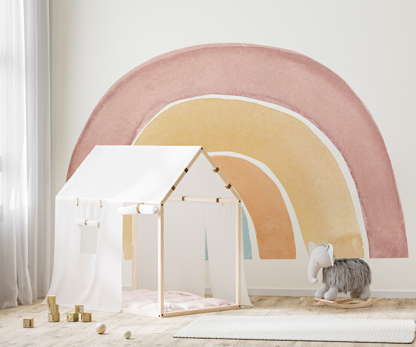 Watercolor Rainbow Colorful wallpaper mural in soft pastels behind a white house play tent and grey elephant rocker