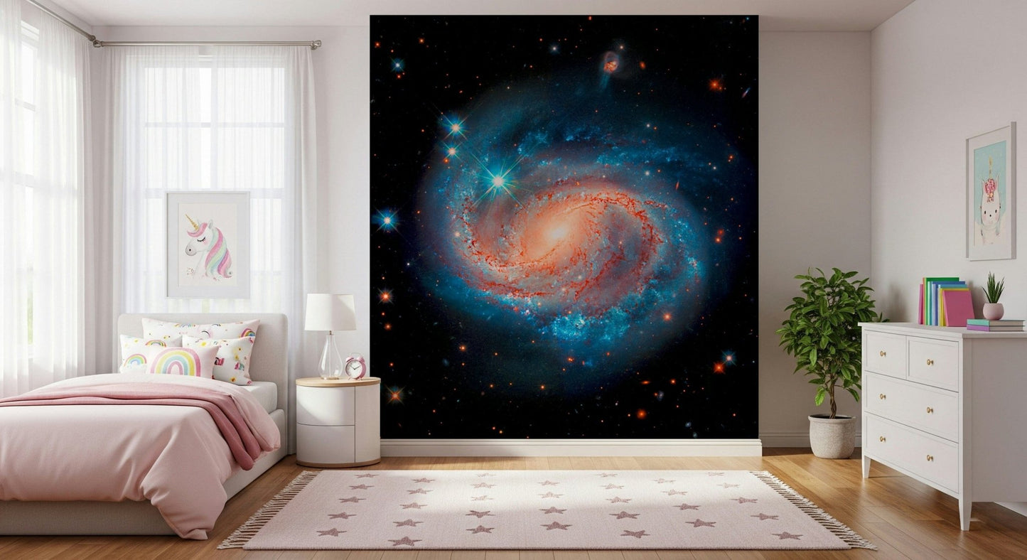 Cosmic Symphony wallpaper mural with a blue and orange galaxy behind a pink bed in a girls bedroom with star rug