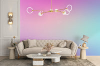Cotton Candy Pastel Gradient wallpaper mural in pink and aqua behind a tufted beige sofa and terrazzo tables in a living room