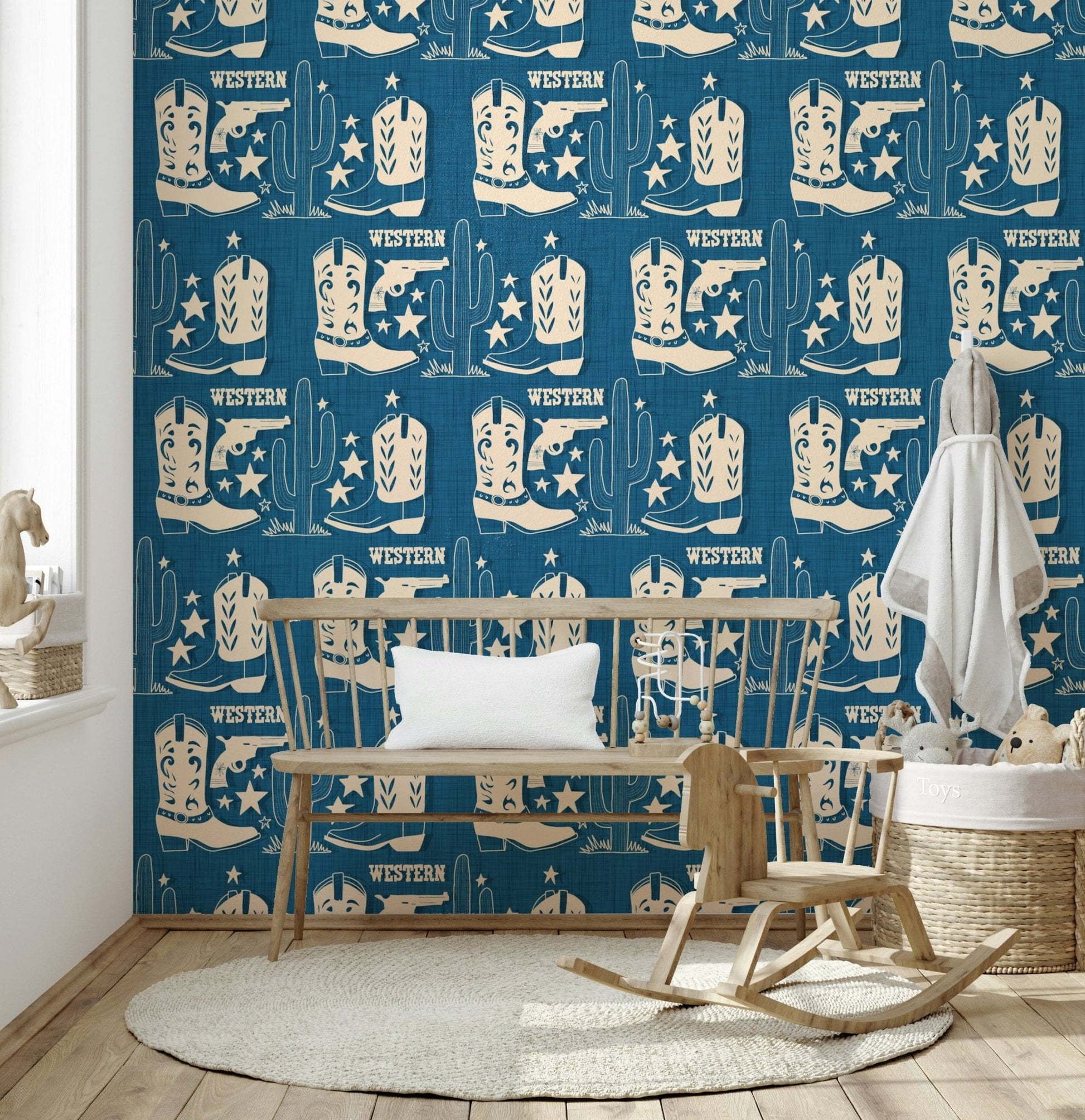 Western-themed wallpaper mural with repeating cowboy boots, cactuses, and star motifs on a textured background.