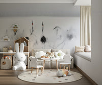 Crane Dance in White wallpaper mural of misty cranes behind a cream sofa and bunny lamp in a nursery