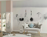Crane Dance in White wallpaper mural of red-crowned cranes behind a cream loveseat with star pillows in a nursery