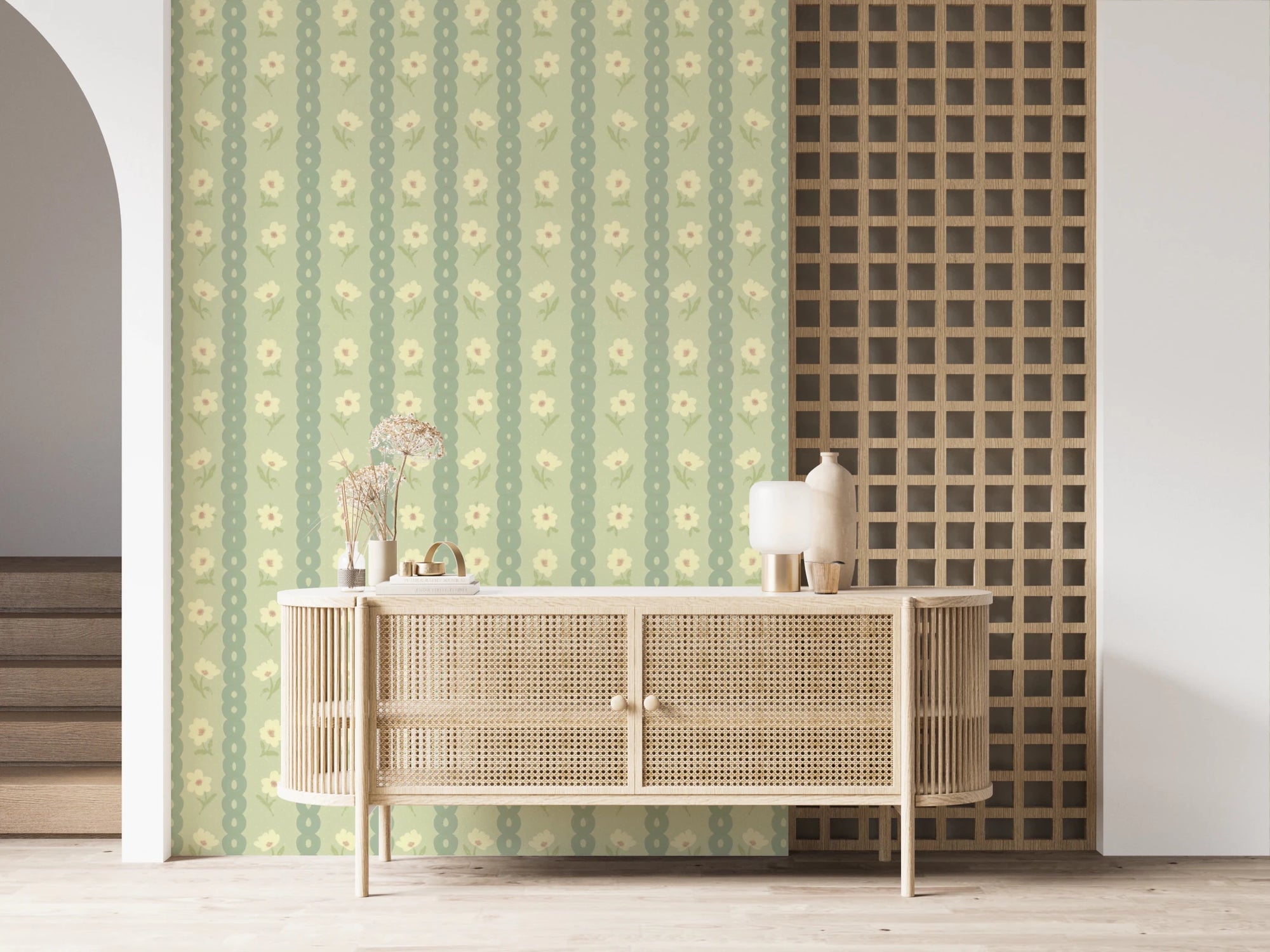 Daisy Chain Delight wallpaper mural in an entryway behind a rattan cane sideboard, sage green stripes with cream daisies