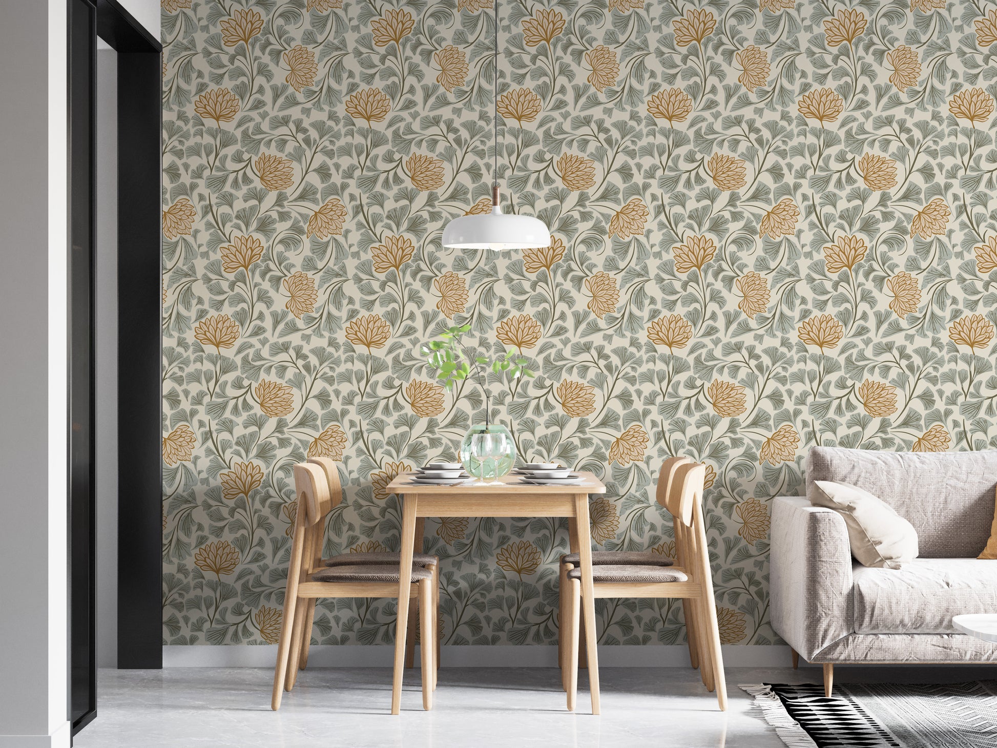 Dancing Bloom wallpaper in sage and amber behind a small wood dining table and beige sofa in a bright living room