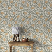 Dancing Bloom wallpaper in grey and amber florals behind a wood console table with a chevron-shade lamp and bowl