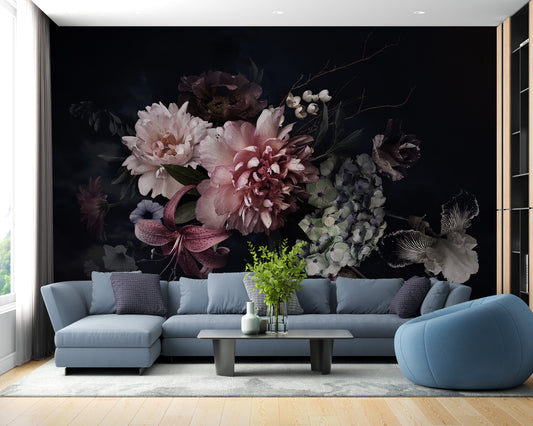 Dark vintage flower bunch wallpaper mural of pink peonies on black behind a blue sectional sofa in a living room