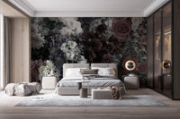 Dark Floral wallpaper mural behind a grey upholstered bed with white and burgundy blooms in a moody bedroom