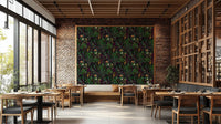 A dining room decorated with a dark botanical mural

