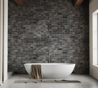 Dark Grey Brick Textured wallpaper mural styled as a living room feature wall behind a sofa and seating in black tones