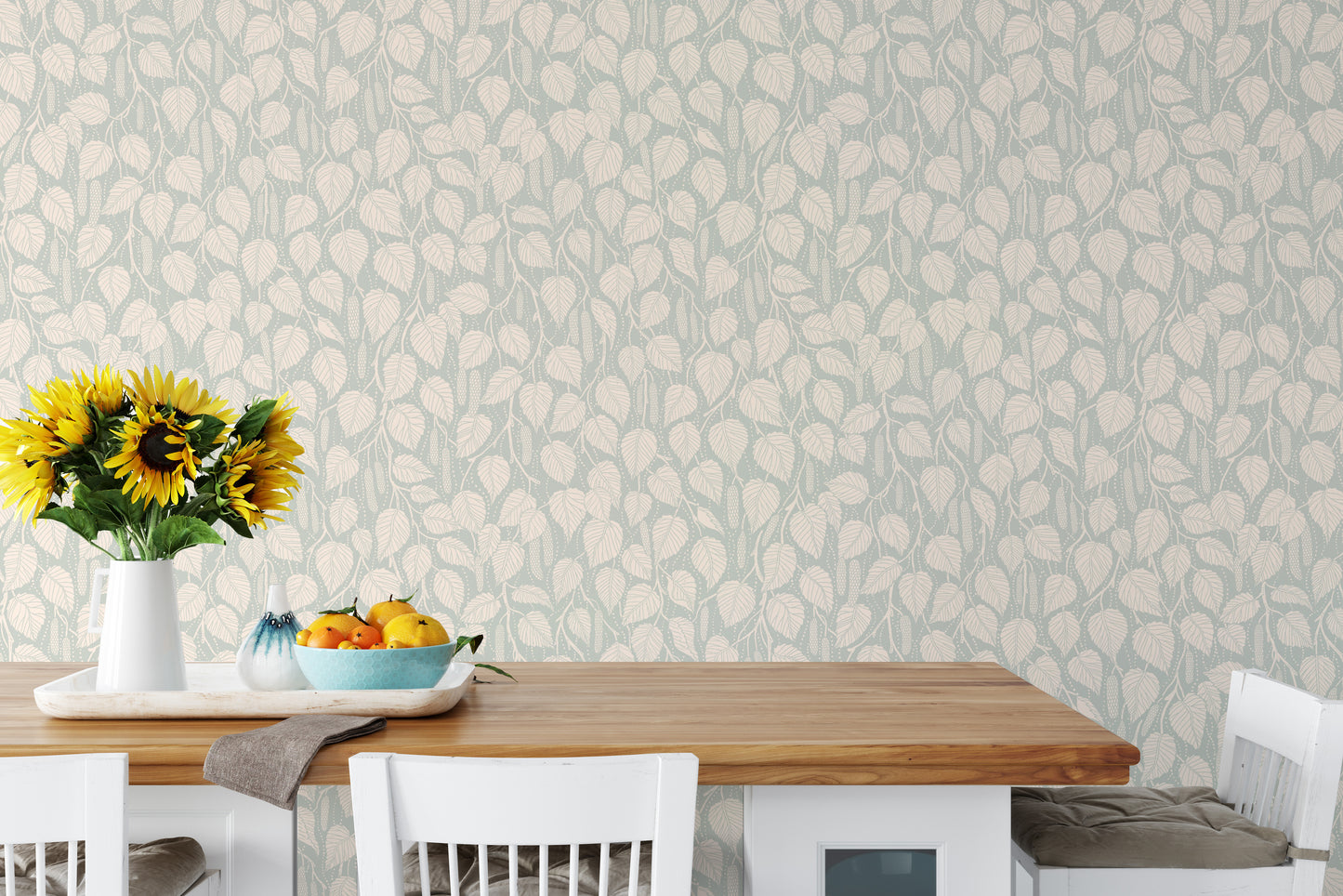 Dewy Birch Branches wallpaper in a dining room with a wood table, white chairs and sunflowers in a vase